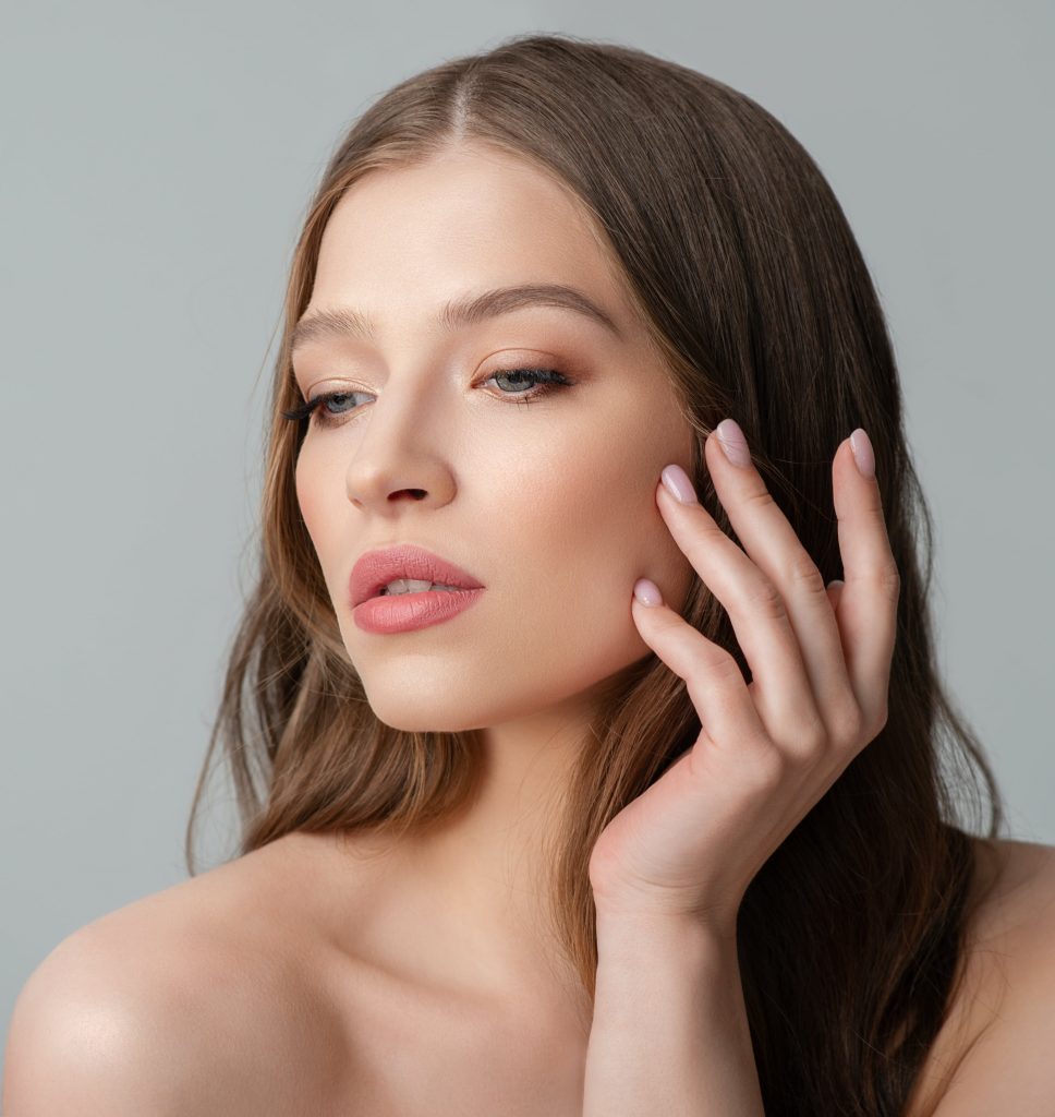 Photo of a beautiful woman touching the side of her face