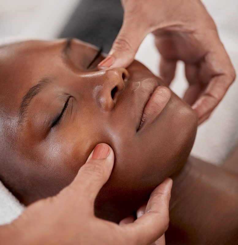 Woman relaxing during a facial skin treatment