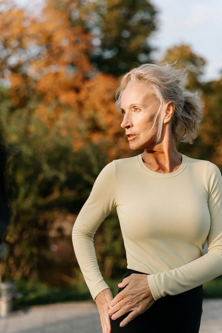 Silver-haired woman exercising outdoors
