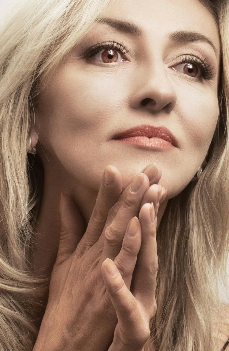 Close-up of a woman with her hand near her face
